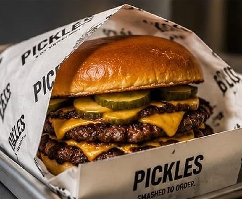 Double smash burger with cheese and pickles in PICKLES printed paper